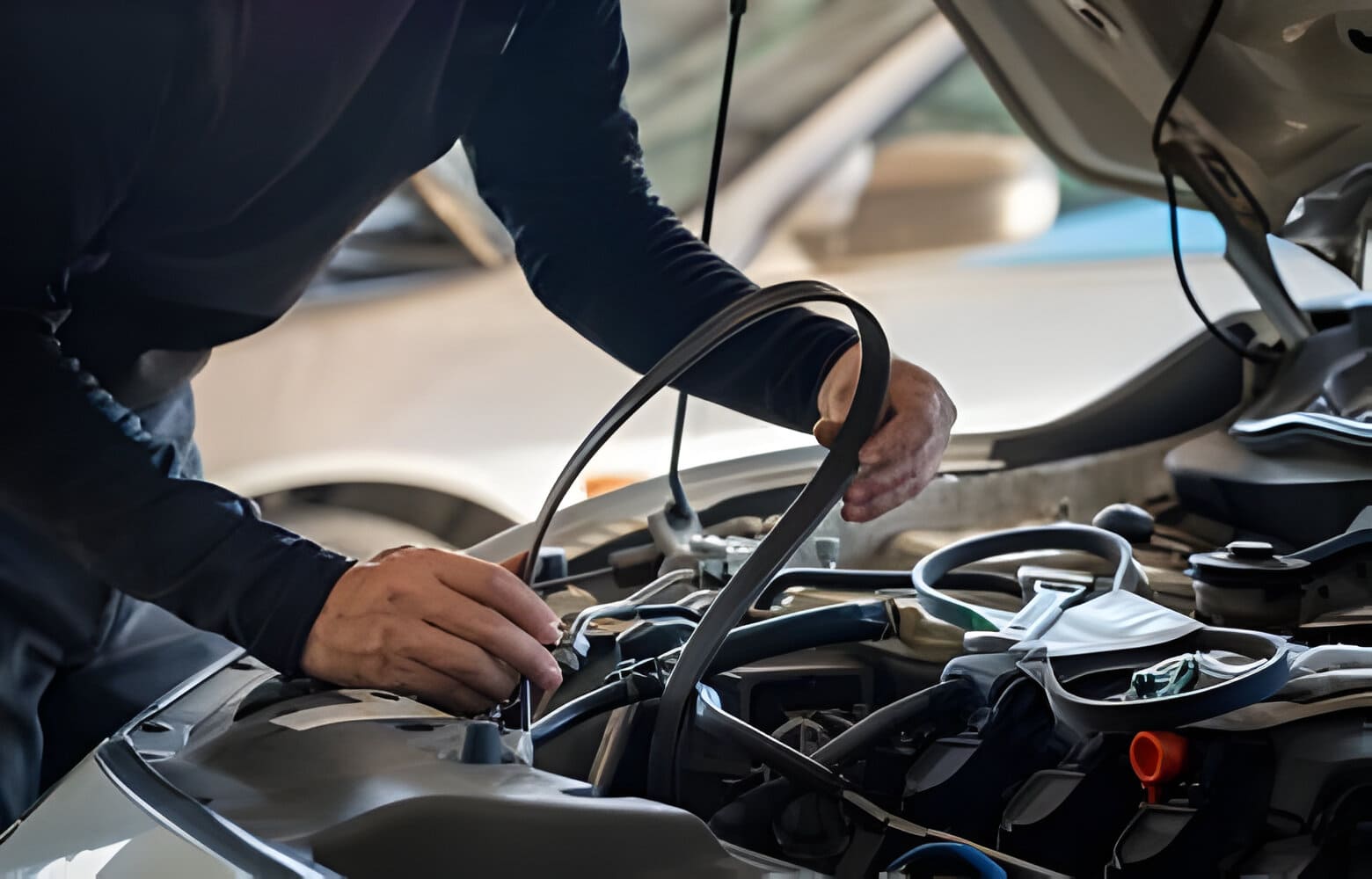 Professional mechanic man holding timing belt